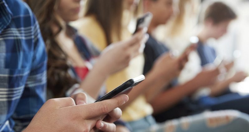 Teenagers in France on mobile phones